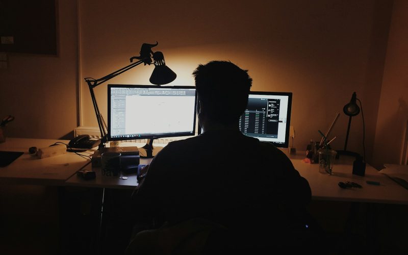 man using computer inside room